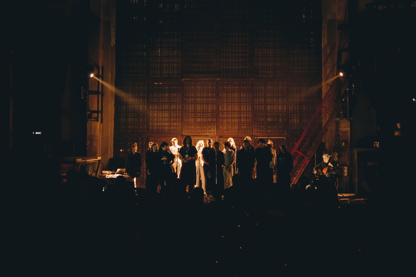 Ensemble on a dark industrial stage